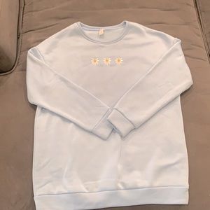 Light blue sweatshirt with three daisies on front